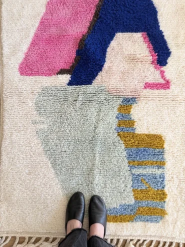 Alfombra Beni Ouarain con colores abstractos tejida a mano sobre fondo crudo.